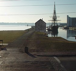 Artist's view of Pedrick Store House in place on Derby Wharf next to Friendship.