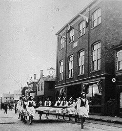 A parade passes St. Joseph Hall in the 1950s. A parade passes St. Joseph Hall in the 1950s.