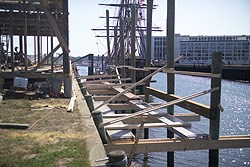 horizontal timbers are attached to pilings driven into the harbor floor next to Derby Wharf.