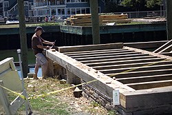 a contractor working on the frame of Pedrick Store House