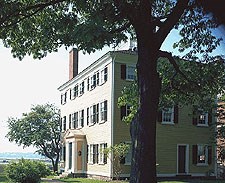 The Hawkes house is a large, square, yellow house with black shutters. The Hawkes house is a large, square, yellow house with black shutters.