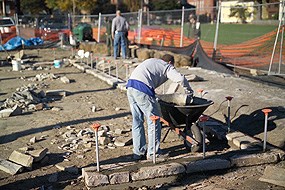 An NPS contractor mixing cement for the warehouse foundation