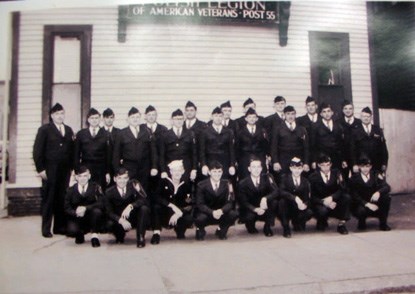A formal portrait of men in uniform outside a building A formal portrait of men in uniform outside a building