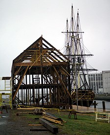 The frame of Pedrick Store House in place on the wharf