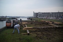 workers assembling timbers into a building frame