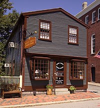 The West India Goods Store is a two story blue clapboarded building. The West India Goods Store is a two story blue clapboarded building.