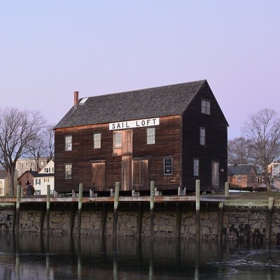 A three-story wooden building on a historic wharf.