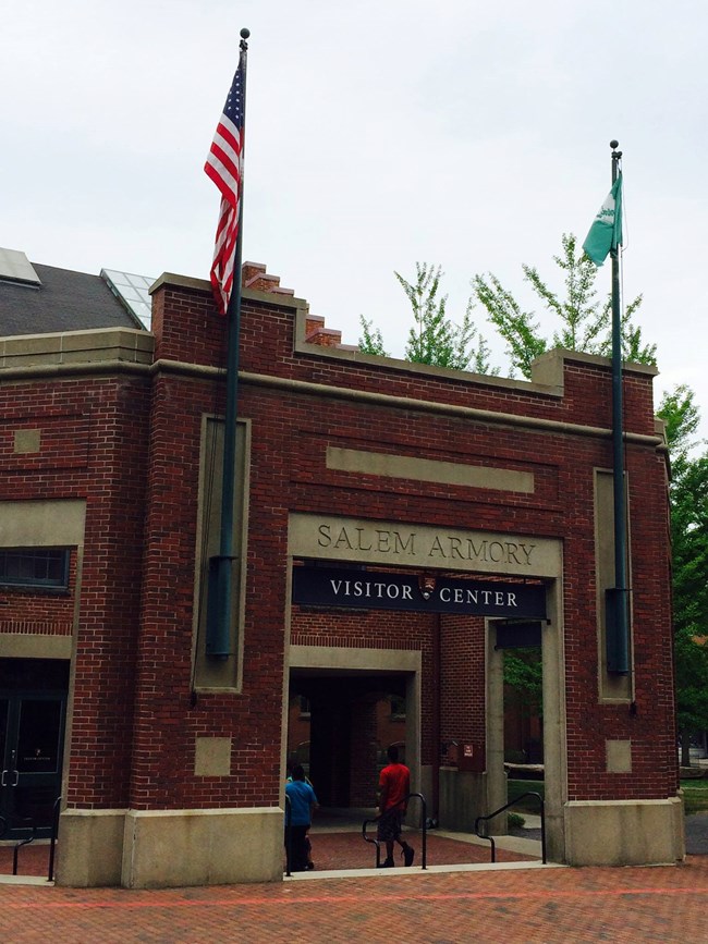 The exterior of a large brick building. A sign reads "Salem Armory Visitor Center"