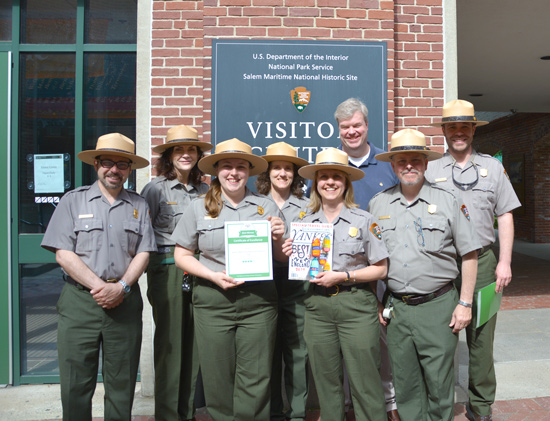 Staff Hold Award Certificate and Magazine Cover