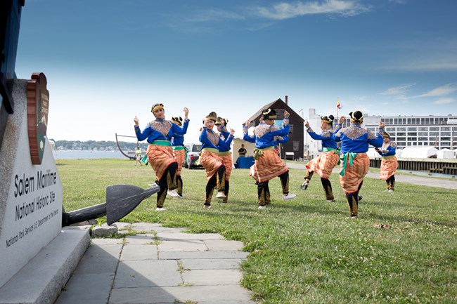 Cultural dance troupe practices on lawn