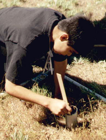 Student gets hands on experience examining environmental changes using quadrants in the field.