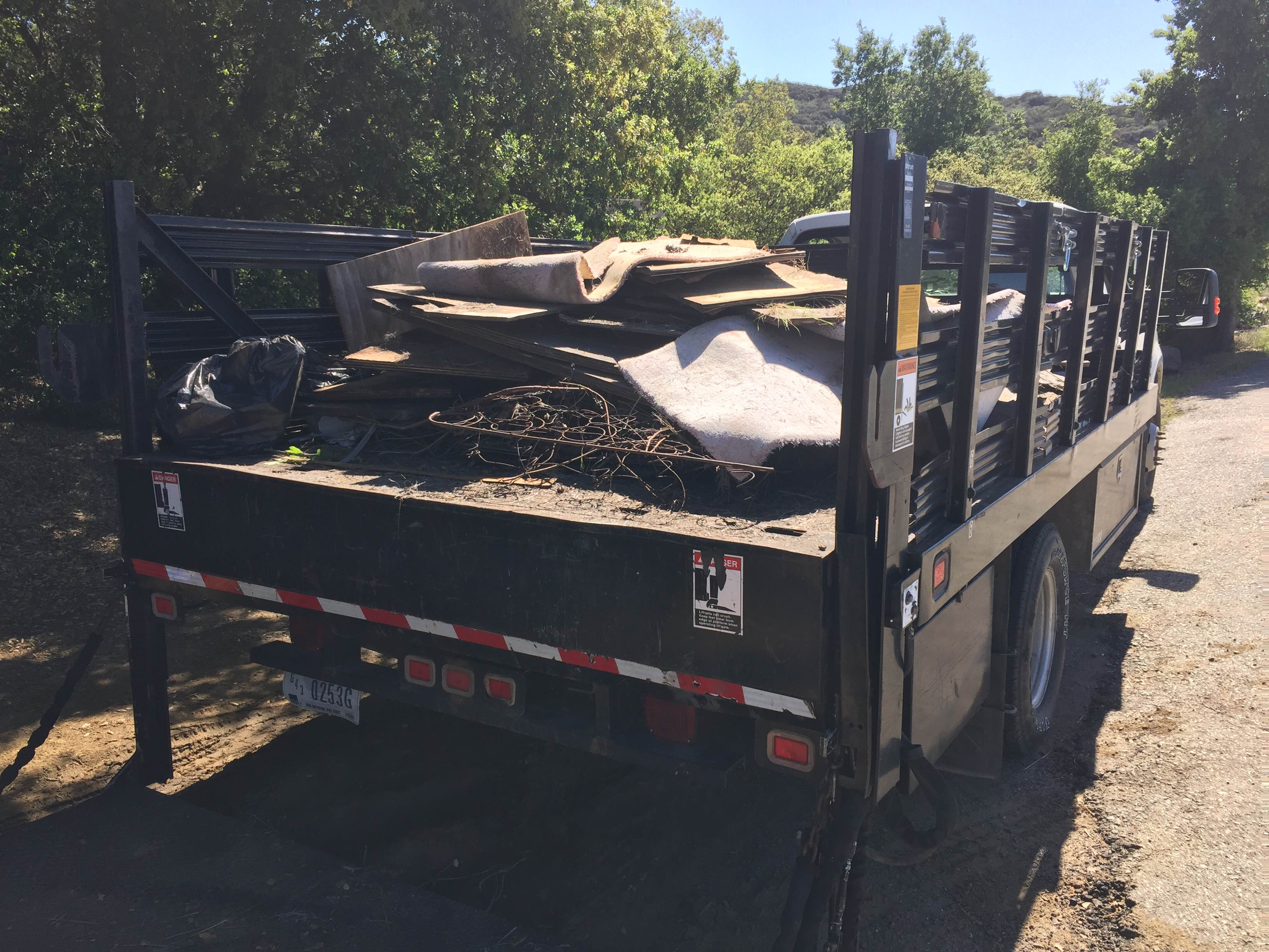 Plywood boards, carpeting, and other trash piled in a truck after the clean-up. (Photo: National Park Service)