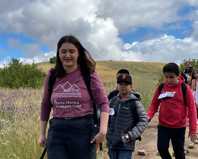 Group of students on a hike with an intern