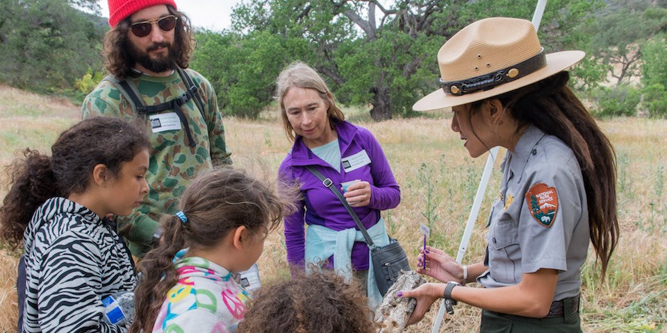 Ranger Kya explains a native tree species to a group Ranger Kya explains a native tree species to a group