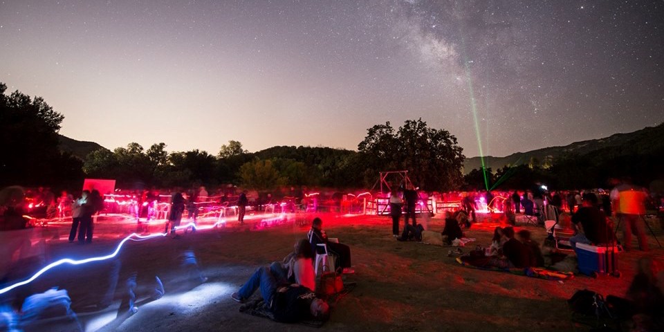 Visitors gaze at the night sky while laser pointers display constellations Visitors gaze at the night sky while laser pointers display constellations