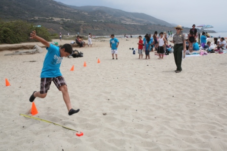 Students race to finish an obstacle course at Leo Carrillo State Beach as part of a ranger-led fitness program. Students race to finish an obstacle course at Leo Carrillo State Beach as part of a ranger-led fitness program.