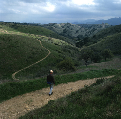 A lone hiker walking through the trails on the mountains.