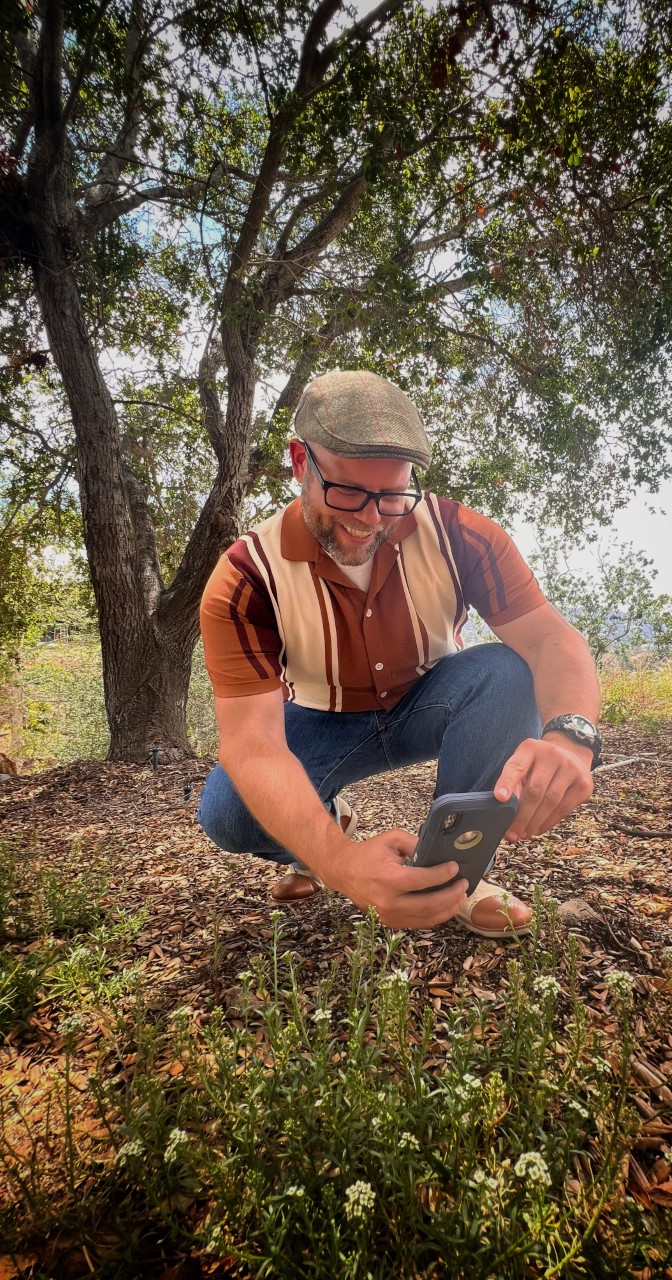 Park visitor taking photos of wildflowers