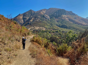 A visitor photographs the Santa Monica Mountains two years after the 2018 Woolsey Fire.