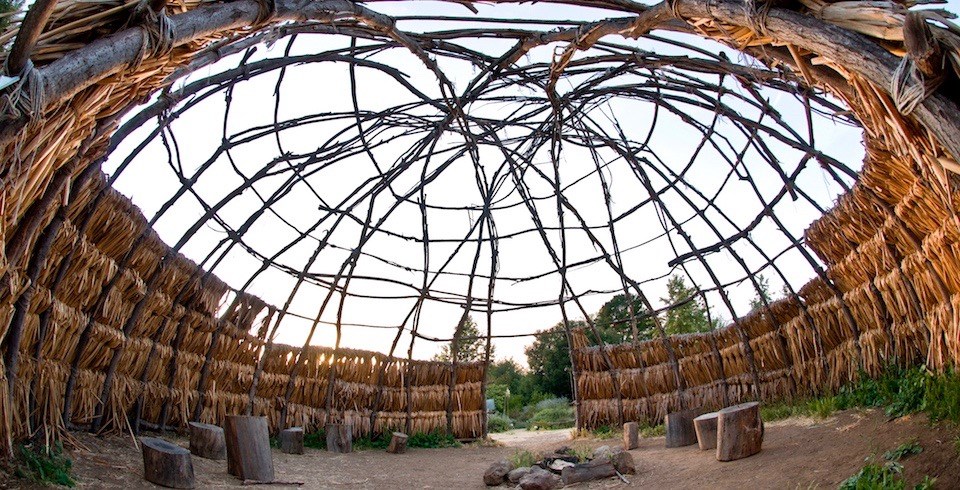 Looking up from within a traditional Chumash wood structure