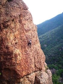 Climber scaling the face of a rock at Echo Cliffs.