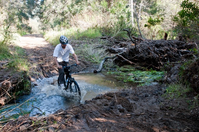 Mountain biker splashing through a puddle