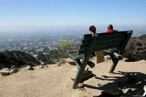 Hikers sit on a bench at Runyon canyon Park. Photo credit Sam Smigelski.