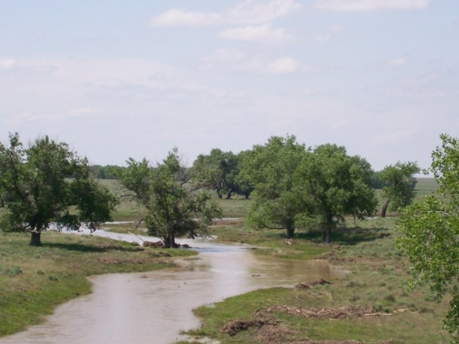 Water flowing down the usually dry bed of Sand Creek after heavy rains in 2007. Water flowing down the usually dry bed of Sand Creek after heavy rains in 2007.