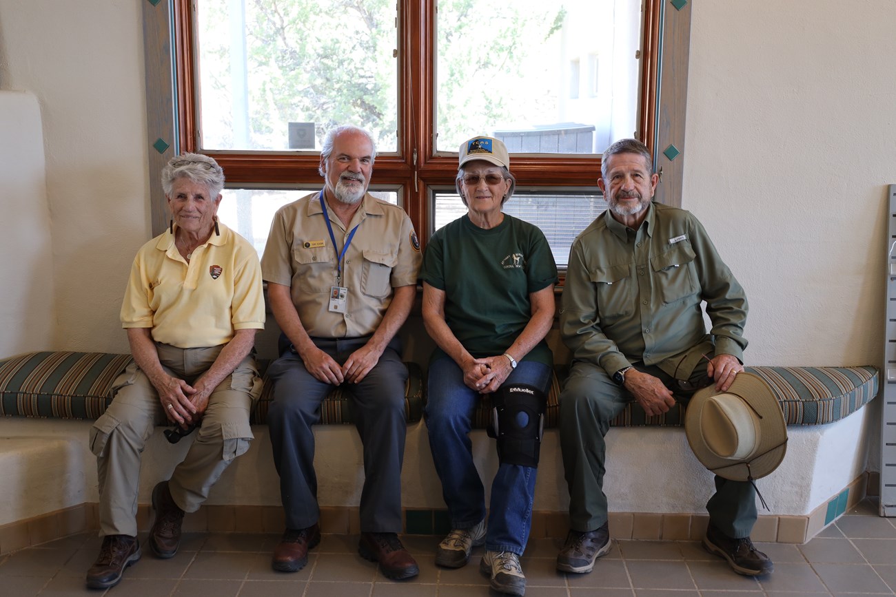 Four people sitting on a bench