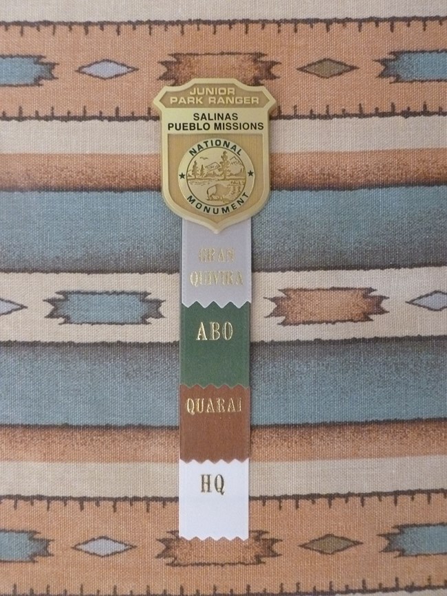 Junior Ranger Badge with a different color ribbon for each site.
