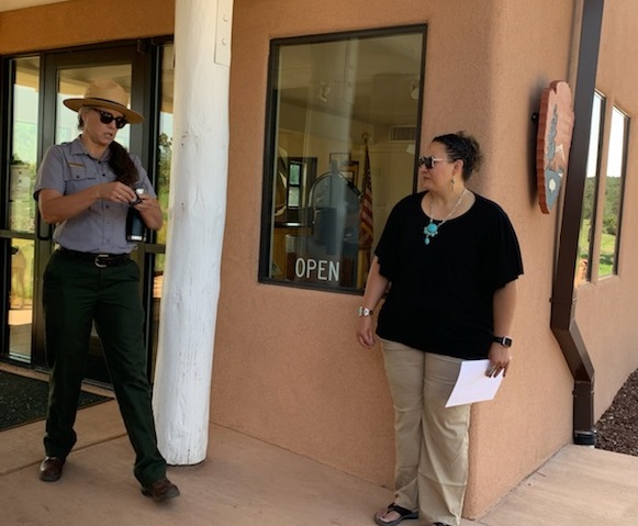 Superintendent Lisa Baldwin talks to a visitor in front of the Quarai Visitor Center.