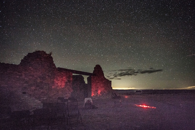 A sky full of stars forms the back drop to the stone walls of an old mission.