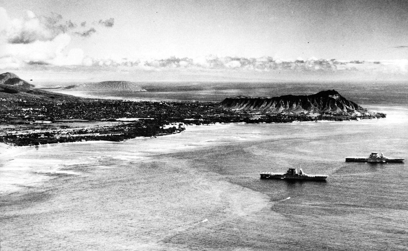 Two ships travel through the waters off Hawaii.
