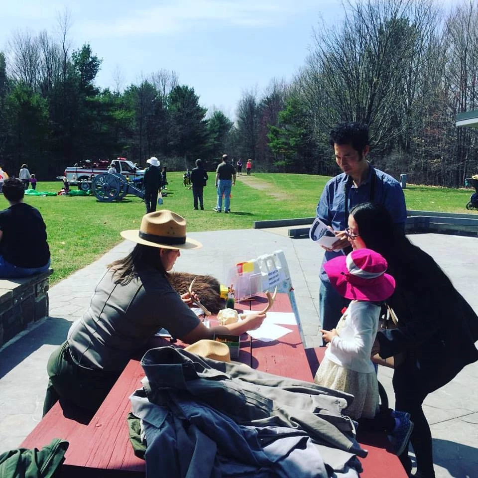 Junior Ranger Day Family checking out deer antlers with Park Ranger
