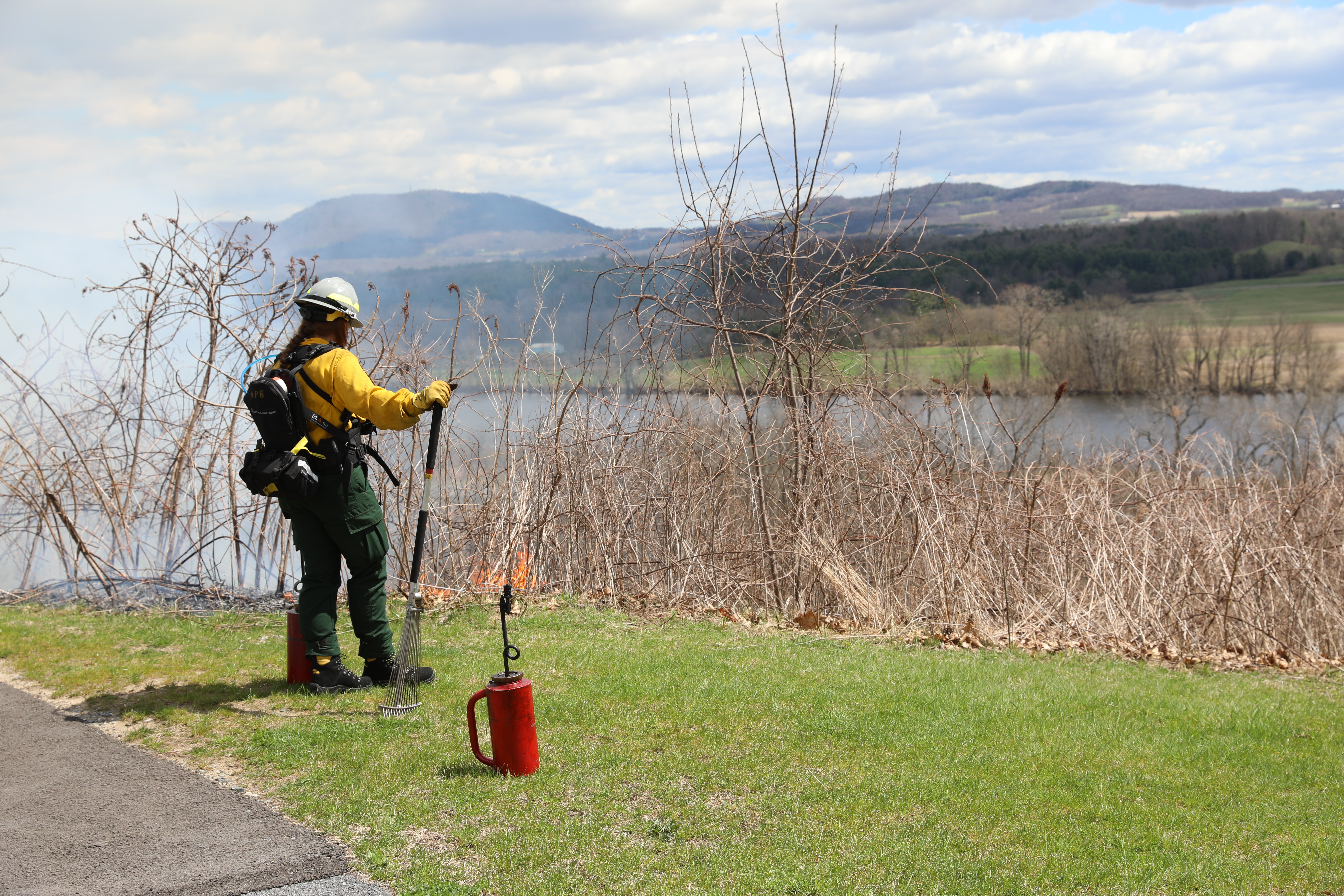 A firefighter monitors a prescribed fire