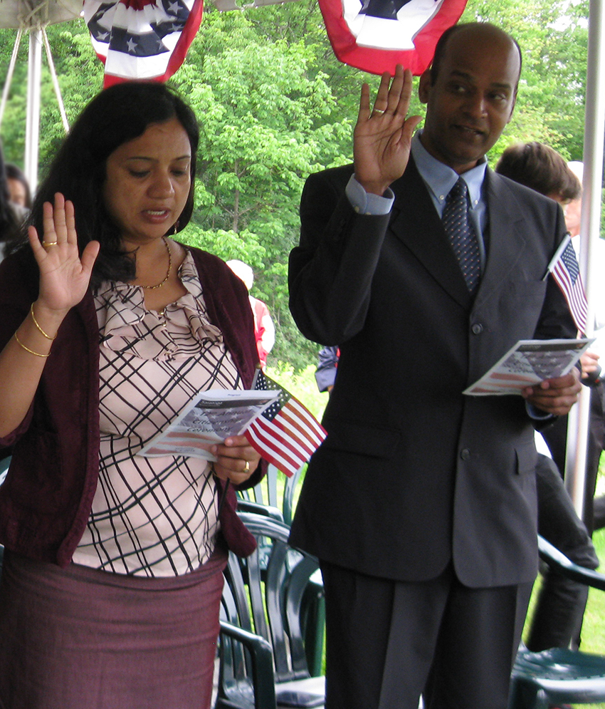 Two new U.S. citizens, a woman and a man, being sworn in.