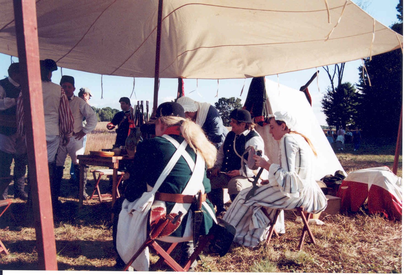 British soldiers gather to eat under a canvas tent