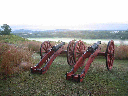 Perched on Bemis Heights, two cannons on red field carriages overlook a misty Hudson River Valley. Perched on Bemis Heights, two cannons on red field carriages overlook a misty Hudson River Valley.