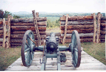 A cannon on Bemis Heights peers through an imposing fortified wooden wall, looking down on the Hudson River Valley.