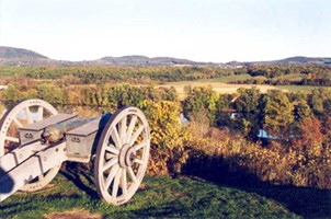 A lone cannon sits on a hill overlooking the Hudson River. An explosion of autumn foliage adorns the river valley. A lone cannon sits on a hill overlooking the Hudson River. An explosion of autumn foliage adorns the river valley.