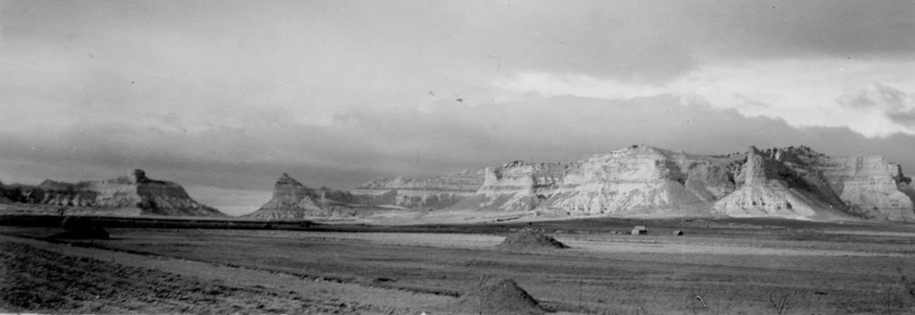 A black and white image of a distinctive sandstone bluff.