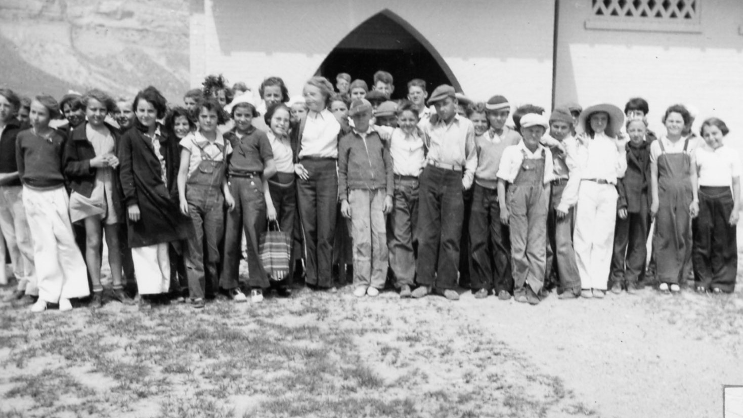A group of students poses in front of a building.