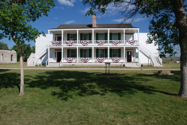 A wood-sided, two story building, painted white.