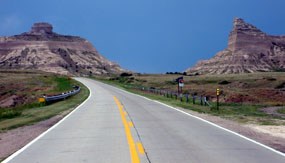 Heading west on highway 92 towards the Scotts Bluff National Monument. Sentinel Rock is seen on the left, and Eagle Rock is seen on the right. Heading west on highway 92 towards the Scotts Bluff National Monument. Sentinel Rock is seen on the left, and Eagle Rock is seen on the right.