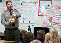 A ranger speaks with children in a classroom A ranger speaks with children in a classroom