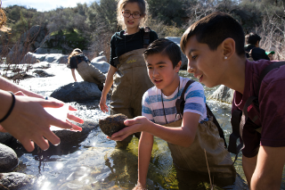 Volunteers help collect stream data.