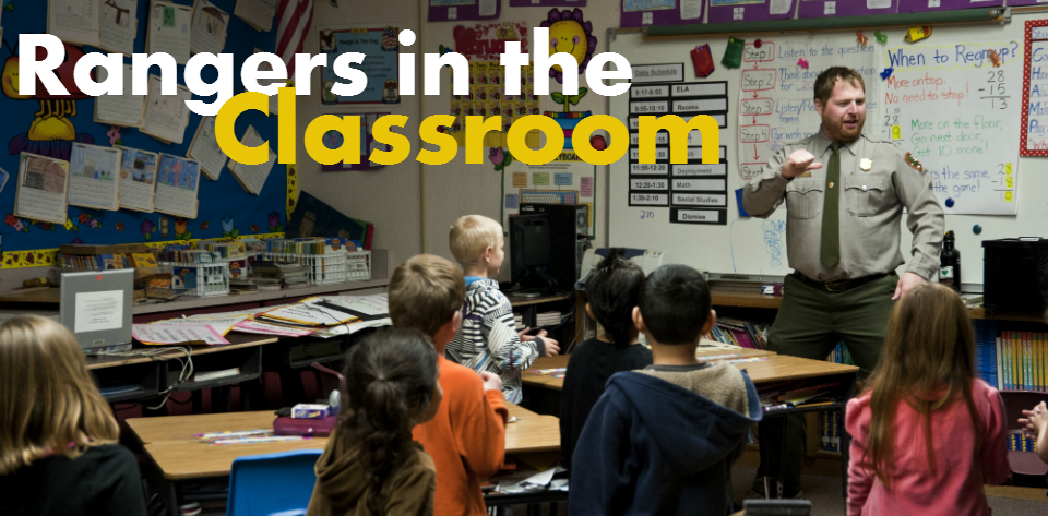 A ranger engages students in a classroom.