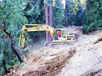 Excavator reworks the grade of a steep hill in Giant Forest Excavator reworks the grade of a steep hill in Giant Forest