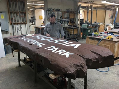 A park signmaker inspects the Sequoia historic park entrance sign in his shop, as he prepares to make restore it.