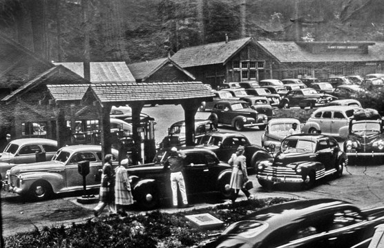 Vintage cars crowd around the old Giant Forest market and gas station.